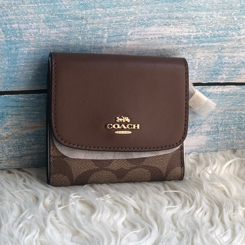 Firm price coach wallet in signature canvas